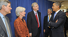 President Obama, Secretary Sebelius, Dr. Collins, Deputy Secretary Corr, and Dr. Holdren talking in a group.