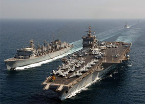 Aircraft carriers sail the open water.