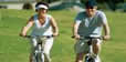 Man and woman riding bikes.