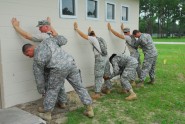 Soldiers from the Florida National Guard's 806th Military Police Company practice searching detainees during a training exercise at Camp Blanding Joint Training Center, July 14, 2011. The 806th MP Company is setting up a mock internment facility to conduct 24 hour operations during annual training. Photo by Sgt. 1st Class Blair Heusdens