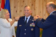 Joseph Kirk Martin is promoted to the rank of Major General in Florida Air National Guard by his wife, Vicki, and Maj. Gen. Emmett R. Titshaw.