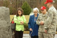 Master Sgt. Al Dirosa (center right) and his wife Becky Dirosa of Norfolk escort Camille Shelby around the 203rd RED HORSE memorial March 3, 2012. Shelby's son, Tech Sgt. Dean Shelby of Virginia Beach, was one of 18 members of the 203rd RED HORSE Squadron killed when their plane crashed March 3, 2001 in a cotton field near Unadilla, Ga. Photo by Sgt. 1st Class A.J. Coyne, Virginia Guard Public Affairs