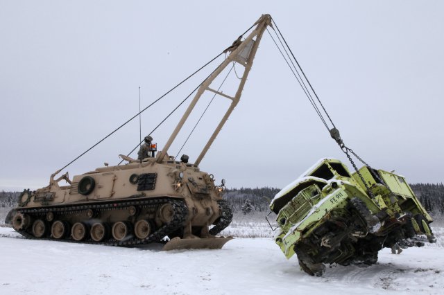 Using an M88 recovery vehicle (left), Soldiers from the 25th Brigade Support Battalion recently practiced vehicle recovery operations they plan to use overseas. CRTC operates the only two M88 vehicles in Alaska.