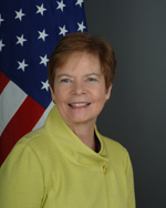 Woman infront of U.S. flag (State Dept. Photo)
