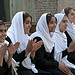 Student from Setara High school watch their classmates play volleyball.