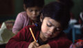 Classroom of pupils writing (UNESCO/Eduardo Barrios) 
