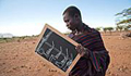 A young Karimojong man takes a look at his notes (UNESCO/Marc Hofer) 
