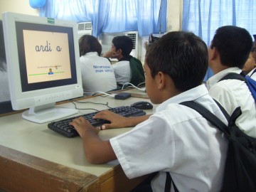 School children sitting in front of computers