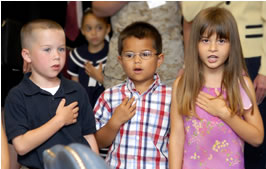 Military children say the pledge of allegiance at the MOU signing on June 25, 2008.