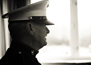 Profile of a retired solder in dress uniform looking out a window.