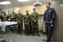 Lt. Cmdr. James Tessier, Surgical Nurse, Surgical Team 5, explains to the Marines of 12th Marine Corps District about his role aboard the USS Anchorage docked in San Diego, CA on Jan 31. Tessier went into detail about how he and the medical team perform various operations to those in need, and answered various questions about his expertise in the medical field.