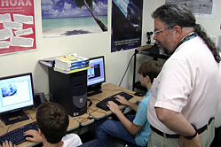 Students take distance learning courses while a teacher checks in at a Department of Defense Education Activity school. DoDEA will open the “doors” of its new virtual high school in the next school year. DoDEA photo