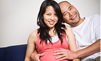 smiling pregnant woman and man