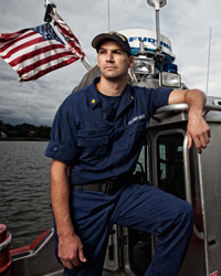 Josh standing on a Coast Guard boat