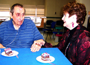 A veteran at the Community Living Center conversing with his wife.