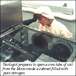 Image of a geologist preparing to open a core tube of soil from the Moon inside a cabinet filled with pure nitrogen.