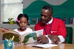 On April 3, 2008, Foster Grandparent Enoch Nelson works with a student on reading comprehension at St. Paul Primary School in Summerton, South Carolina.