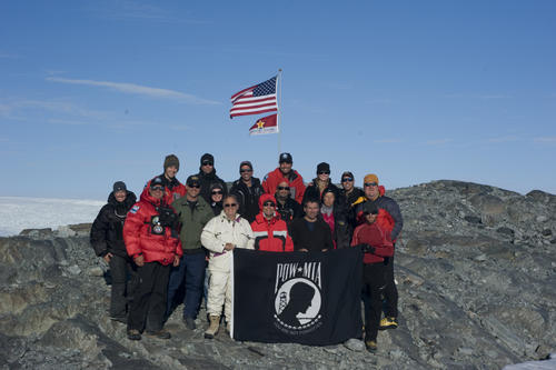 An expedition team displays the POW/MIA flag in honor of the expedition to find the crash site of a WWII Coast Guard Grumman Duck rescue aircraft near Koge Bay, Greenland, Aug. 28, 2012. U.S. Coast Guard photo by Petty Officer 2nd Class Jetta H. Disco.