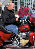 On the third anniversary of his survival, recently retired Sgt. Maj. Raymond H. Mackey, a double amputee with Wounded Warrior Battalion East, mounted his brand new Harley Davidson Tri-Glide for the first time on Dec. 23, 2012, in Jacksonville N.C. Mackey, who has ridden motorcycles for more than 35 years, lost his legs in an improvised explosive device accident while serving with 3rd Battalion 10th Marine Regiment, in Helmand province Afghanistan in 2009.