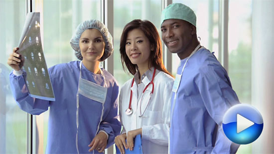 A group of health care workers reviewing a x-ray film.