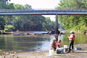 Picture of hydrologists taking a water sample.