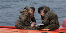 Marines with III Marine Expeditionary Force plot their next move Jan. 31 at White Beach Naval Facility during a maritime navigation course. The two-week course taught students techniques needed to navigate small boats in open waters from over the horizon. 