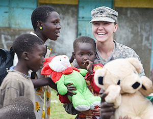 Staff Sergeant (SSG) Sonya Barker, 490th Civil Affairs Battalion - Charlie Company Team Sergeant shares a light moment with Orphans in Uganda soon after her team donated toys and scholastic materials to their Orphanage.