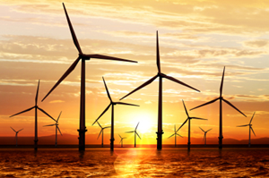 wind turbines generating power at sunset