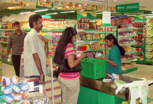 People buying food at a grocery store in South India.