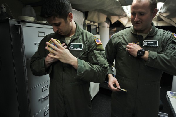 Upon taking shift, 2nd Lt. A.R. Hines and Capt. Ryan Fonnesbeck switch their squadron patches to the Strategic Command patches worn by missile combat crews while on alert duty.