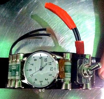 A watch with fuses, wires, and a toggle switch.