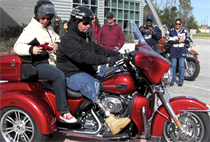 On the third anniversary of his survival, recently retired Sgt. Maj. Raymond H. Mackey, a double amputee with Wounded Warrior Battalion East, mounted his brand new Harley Davidson Tri-Glide for the first time with his wife on Dec. 23, 2012, in Jacksonville N.C. Mackey, who has ridden motorcycles for more than 35 years, lost his legs in an improvised explosive device accident while serving with 3rd Battalion 10th Marine Regiment, in Helmand province Afghanistan in 2009.