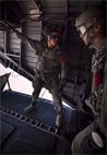 Sergeant Nathanial Contreras, jump master, Force Reconnaissance Platoon, 15th Marine Expeditionary Unit, gives the "go" signal to Marines from his unit to begin an 8,000-foot freefall jump from a CH-153E Super Stallion, HMM 364 (Rein), 15th MEU, Feb. 8. The 15th MEU is deployed as part of the Peleliu Amphibious Ready Group as a U.S. Central Command theater reserve force, providing support for maritime security operations and theater security cooperation efforts in the U.S. 5th Fleet area of responsibility. (U.S. Marine Corps photo by Gunnery Sgt. Jennifer Antoine/Released)