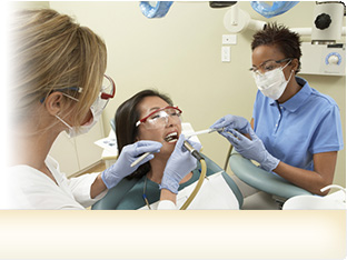 Nurse assisting dentist during an teeth cleaning