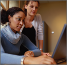 Two women at a computer.
