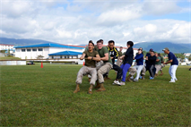 Marines and Japan Ground Self-Defense Force members work together in a tug-of-war match during a fall social at Combined Arms Training Center Camp Fuji Sept. 29.