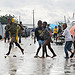 Children walk across a wet roadway