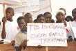 Ghanaian children holds signs to promote TB treatment