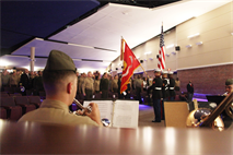 Civilians and service members show respect while colors are presented during a ceremony at the Marine Corps Air Station Cherry Point Theater Friday, celebrating the legacy of the Montford Point Marines. From 1942 to 1949, approximately 19,000 men trained at Montford Point, then the Marine Corps’ boot camp for African American recruits.