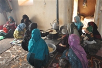 Women in Band-e-Amir cook on a fuel-efficient stove