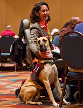 An AW2 Veteran in a wheelchair with a service dog