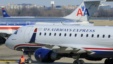 A US Airways Express plane departs from a gate past an American Airlines plane at the Ronald Reagan Washington National Airport in Arlington County, Virginia, February 10, 2013.