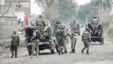 Soldiers arrive and take position near the site of a police station after it was attacked in Bannu, February 14, 2013.