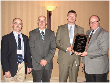 OSM's Appalachian Region Director, Tom Shope (right) presents the 2010 ARRI Excellence in Reforestation Regional Award to officials from Apogee Coal (left to right) Kent DesRocher, Vice President & General Manager; Larry Damron, Senior Environmental Engineer; Kevin Baker, Manager Of Engineering & Environmental Affairs. (Photo by Linda Keene.)