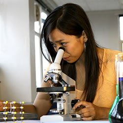 Woman looking through a microscope