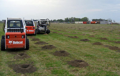 Using Bobcats with solid augers to create more holes to plant more (3,500) trees.