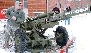 Capt. Chad Hunara, rear detachment commander, 2nd Bn., 32nd FA Regt., left, examines a Howitzer 383 in front of a small group of spectators at a rededication ceremony Jan. 31 at Fort Riley.