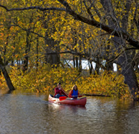 Photo of person canoeing down a river