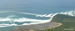 View of tsunami waves hitting a shoreline.