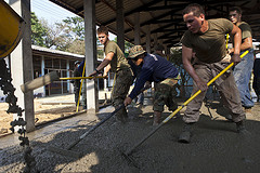 Rake concrete while constructing a classroom during Exercise Cobra Gold 2013